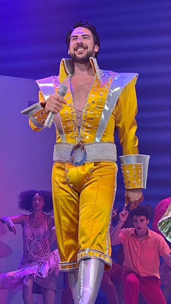John-Paul Birss performing on stage in costume